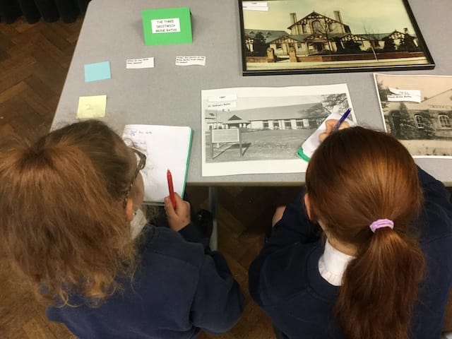Two of Year 5 looking at images of the three Brine Baths